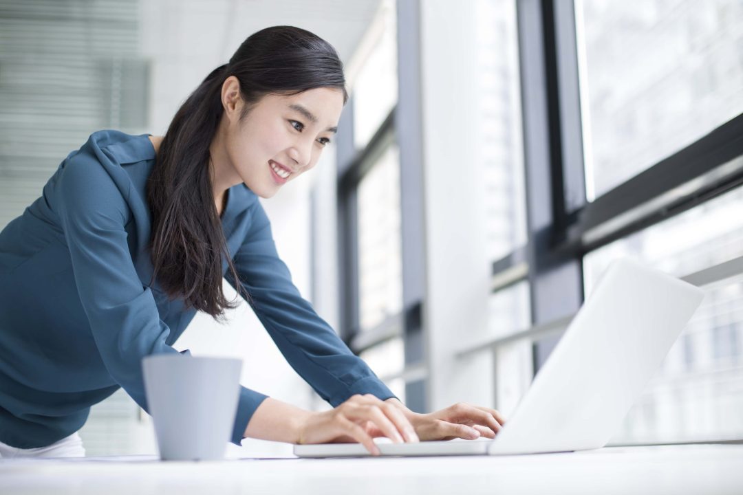 young-businesswoman-using-laptop-in-office-2022-03-24-21-14-09-utc